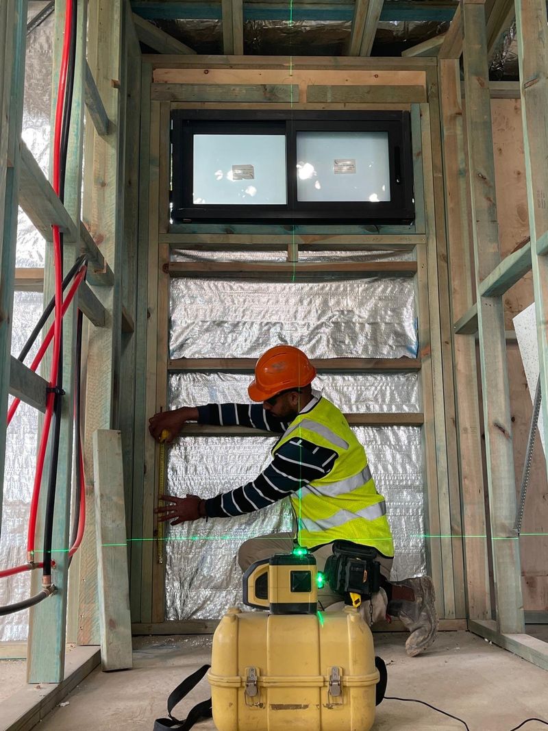 Foil insulation fitted between wall studs before sheeting.