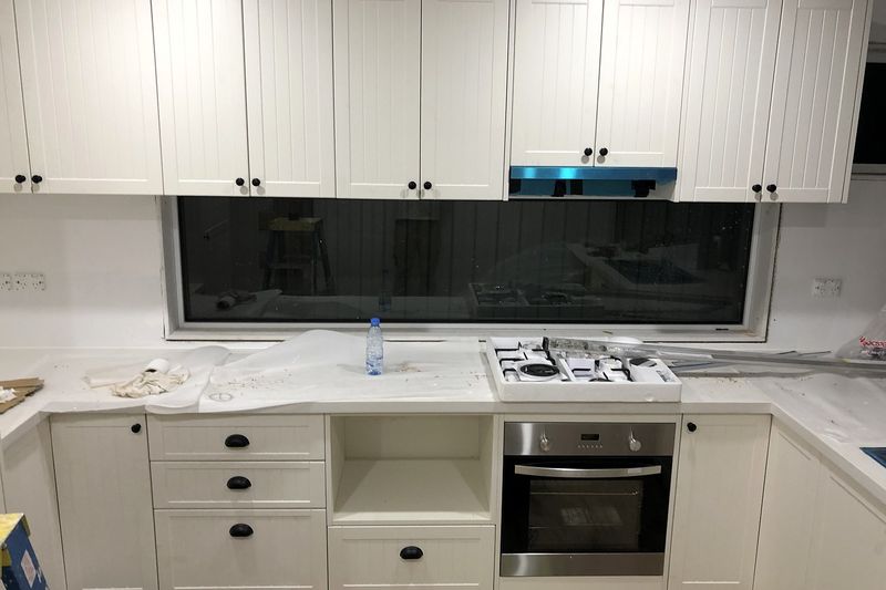White shaker kitchen with gas cooktop in the finished granny flat