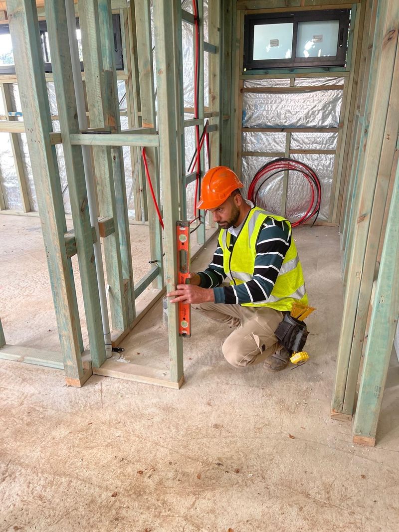 Wall frame checked for level ahead of insulation and sheeting.