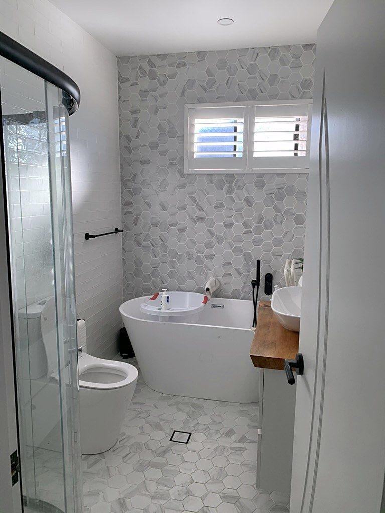 Completed Sydney bathroom fitted with shutters and a freestanding tub.