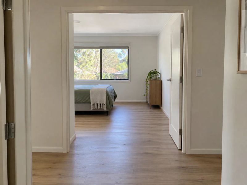 Widened doorway with the architrave made good, opening from the hallway into a bedroom