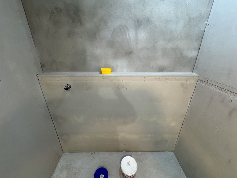 Waterproofing membrane applied to the shower recess walls and floor before tiling