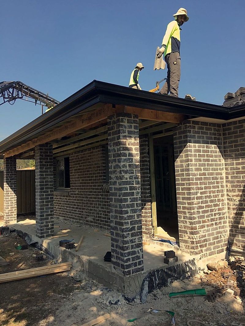 Secondary dwelling under construction with a tradesperson working on the roof