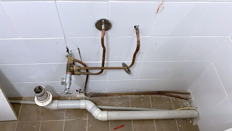 Copper pipework roughed in ahead of a wall-mounted bath tap.