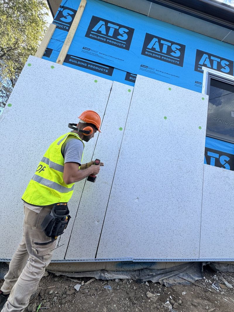 Sarking fitted to an external wall from a scaffold platform.