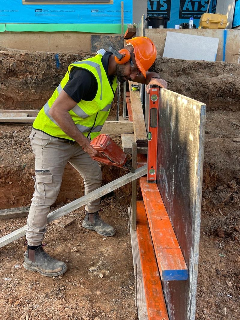 Fixing a new timber fence panel into place.