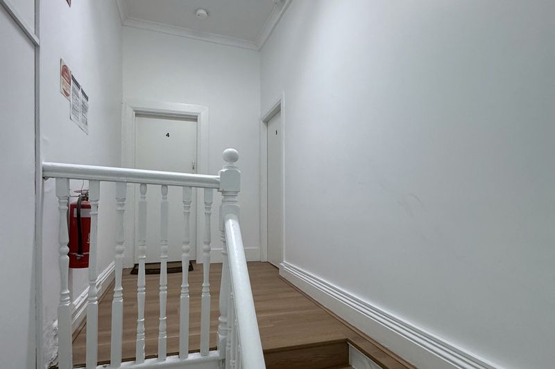 Refurbished staircase with timber treads and a white balustrade