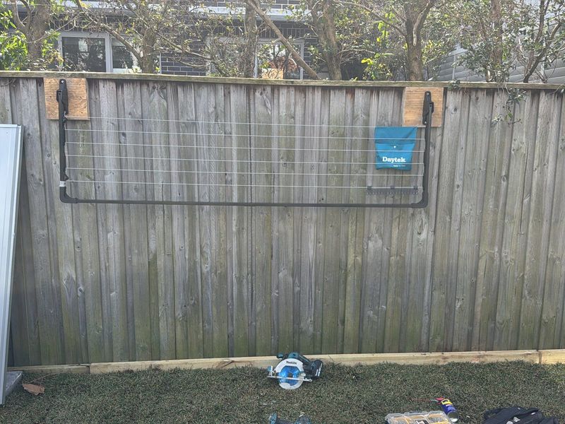 Weathered timber paling fence and gate before replacement