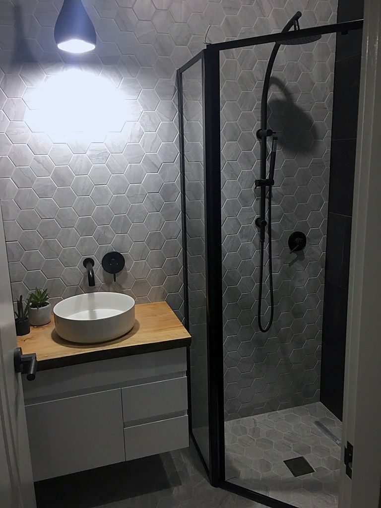 A corner shower and vessel sink furnish this finished Sydney bathroom.
