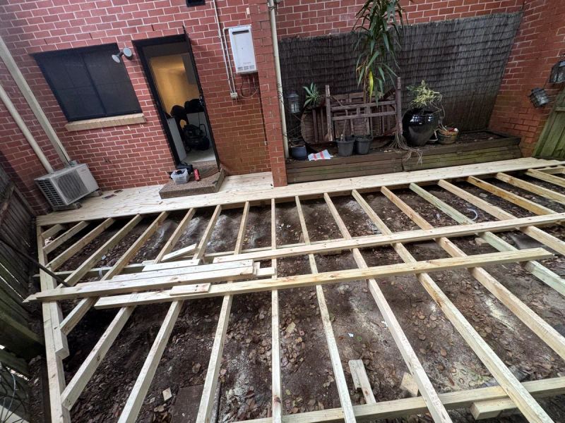 New joists running up to the back of the brick house, ready for decking