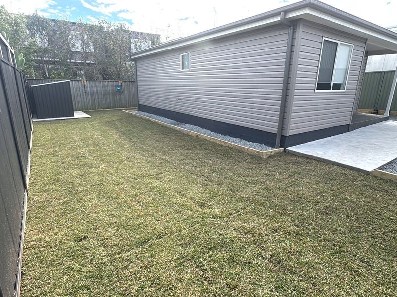 Completed granny flat with grey cladding and a gravel surround