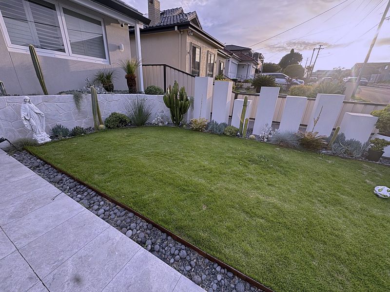 A paved Sydney courtyard features decorative white block detailing.