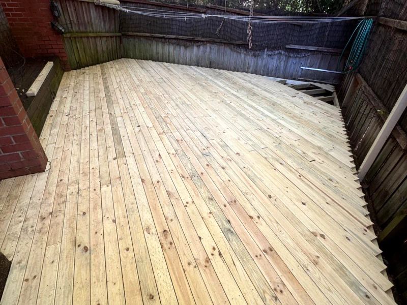 After: the full courtyard re-decked in new treated pine boards